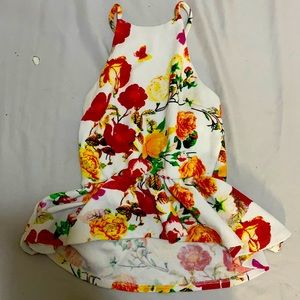 This is a halter top crop top shirt.open back with a cross look. White, floral